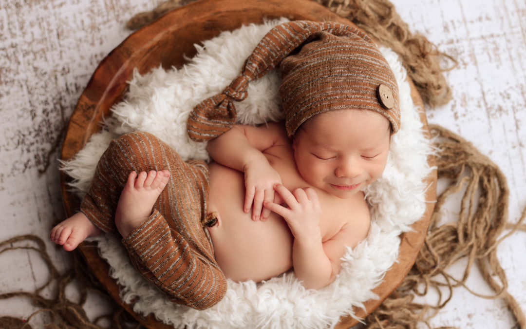 Newborn boy posed in a bowl in Medford, Oregon.