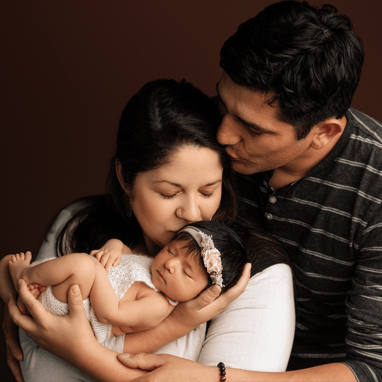 Mother and father holding newborn baby girl in Grants Pass Oregon.