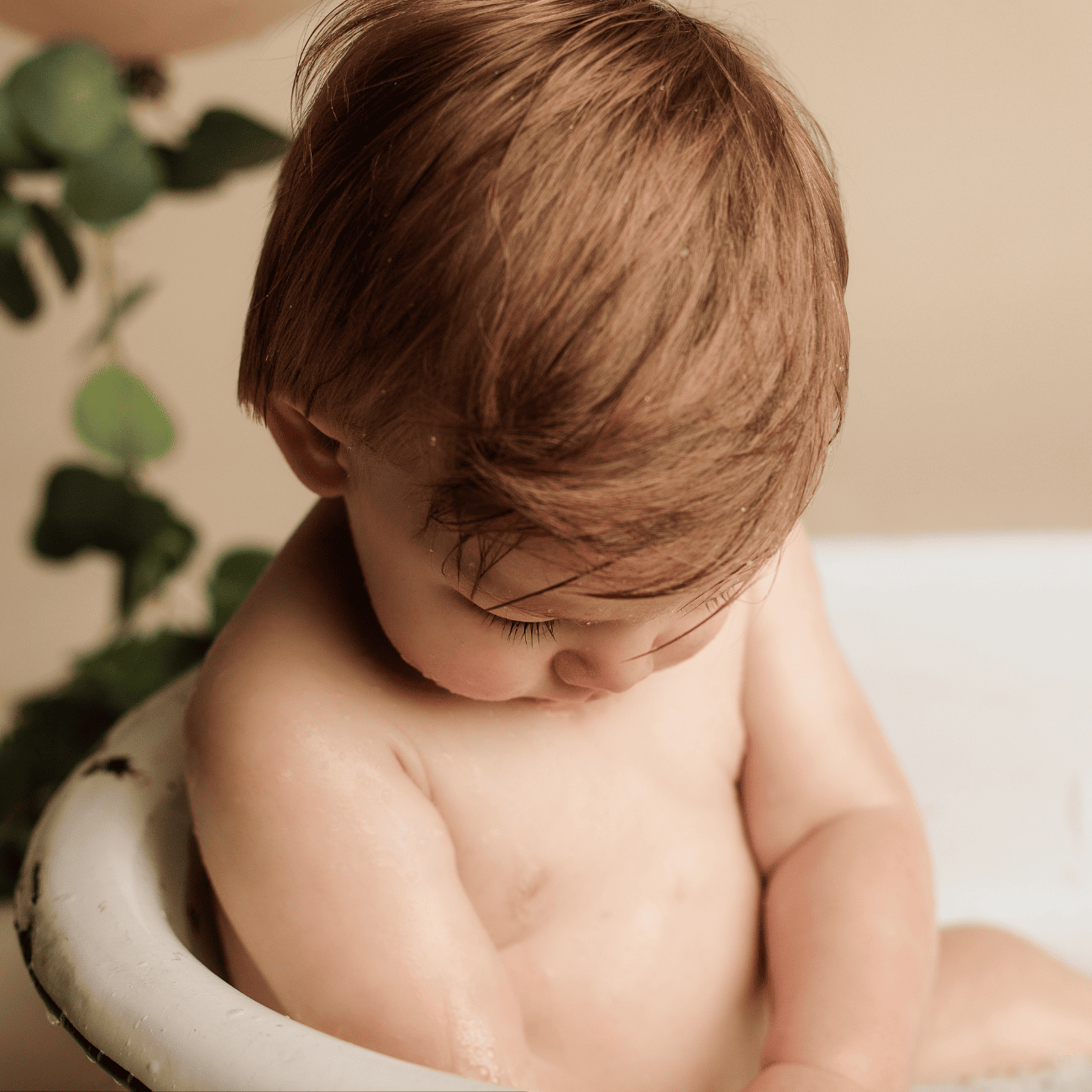 One year old photography milestone session close up boy in bath tub.