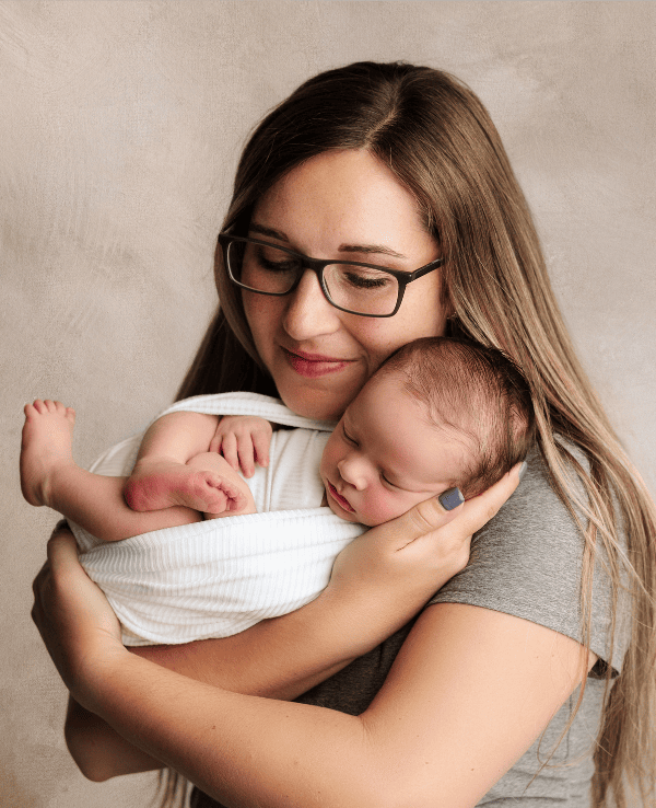 Mother holding her newborn baby boy in Grants Pass, Oregon studio.