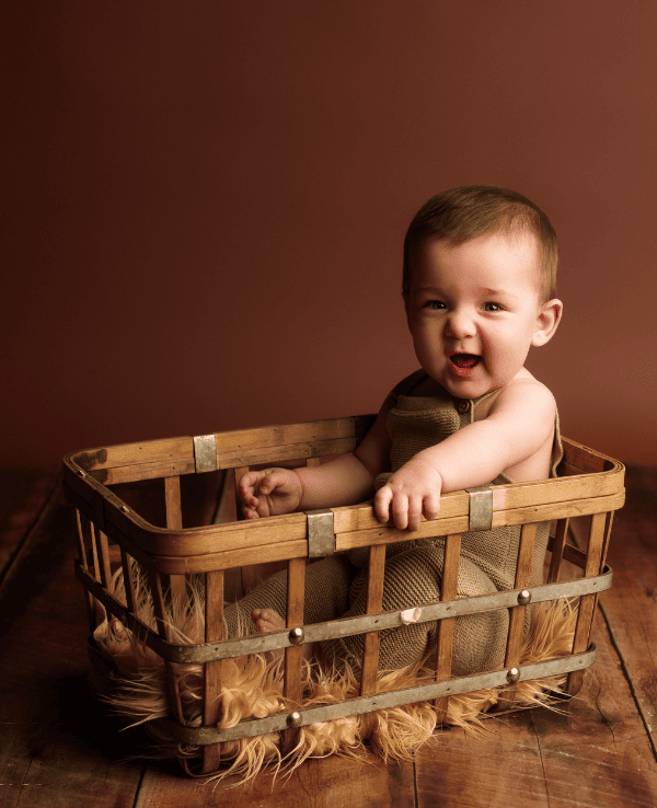 Six month old in basket in Grants Pass Oregon photography studio.