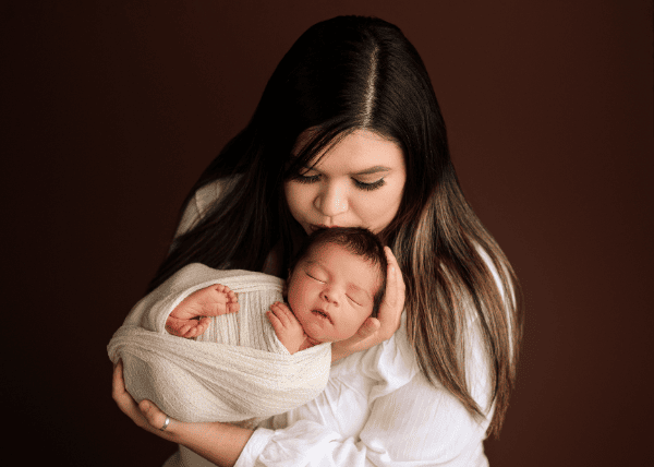 Mom holding her newborn baby boy in Grants Pass, Oregon studio.