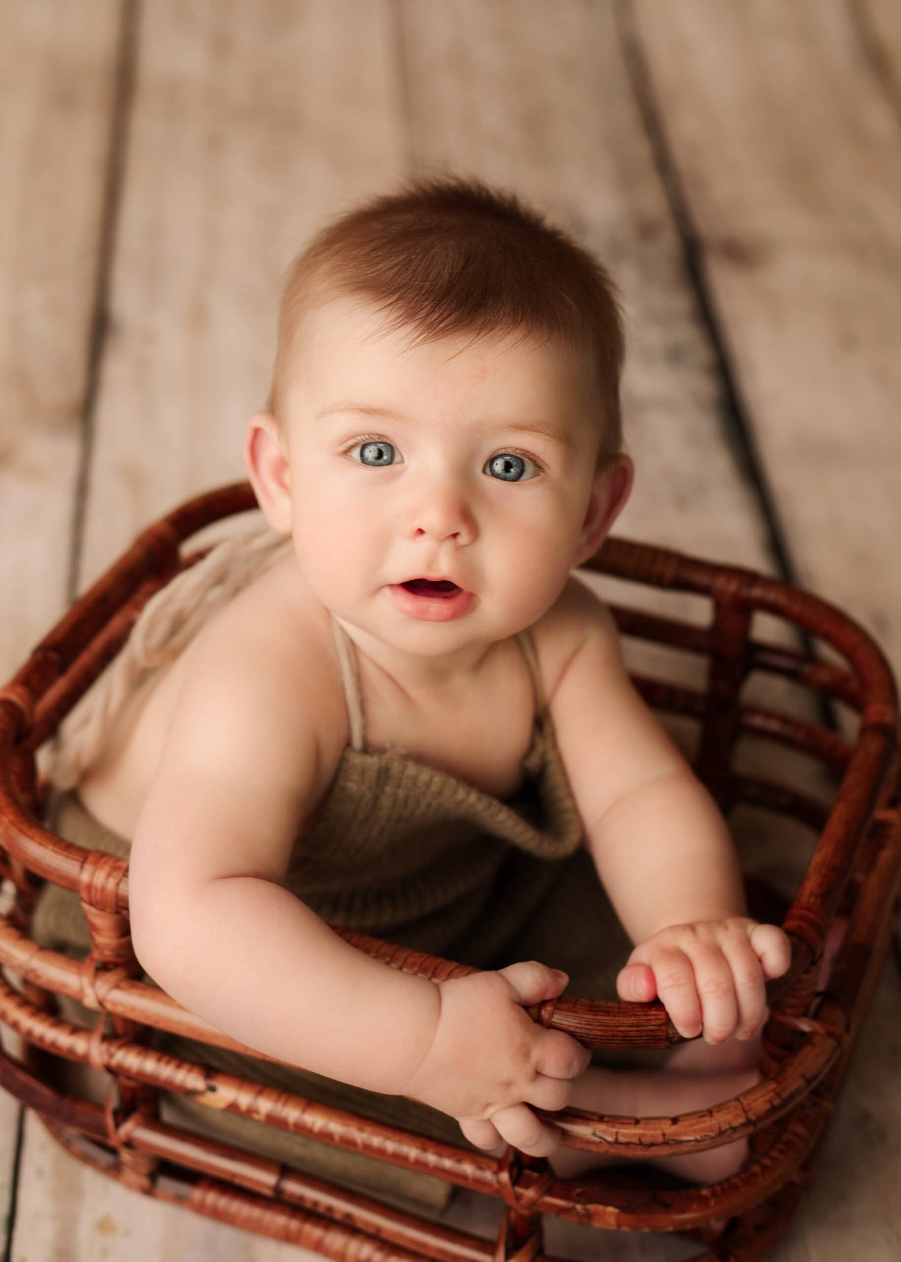 Six month boy in basket for a milestone photography session in Grants Pass, Oregon