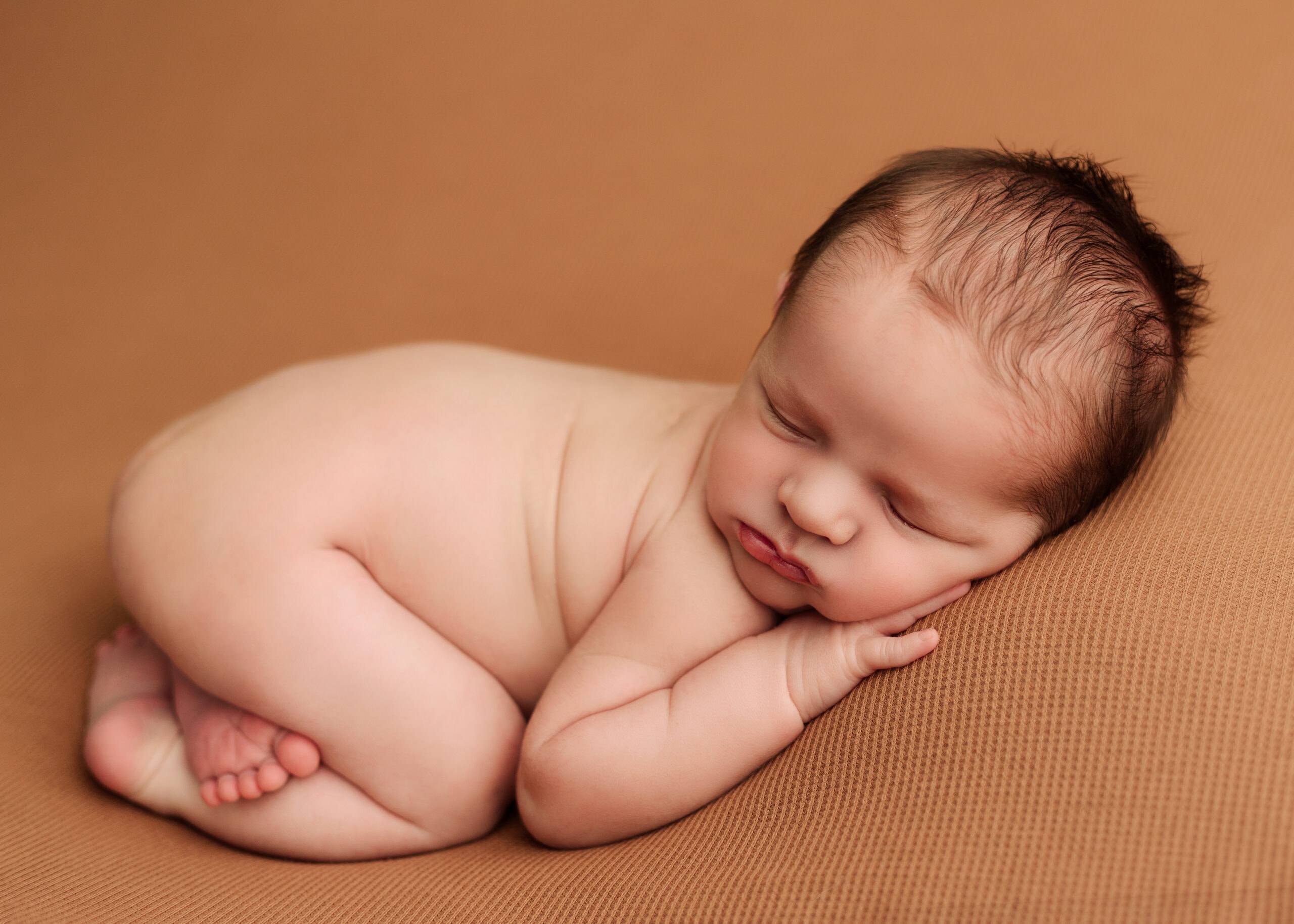 Medford, Oregon Newborn boy in a photographers studio.