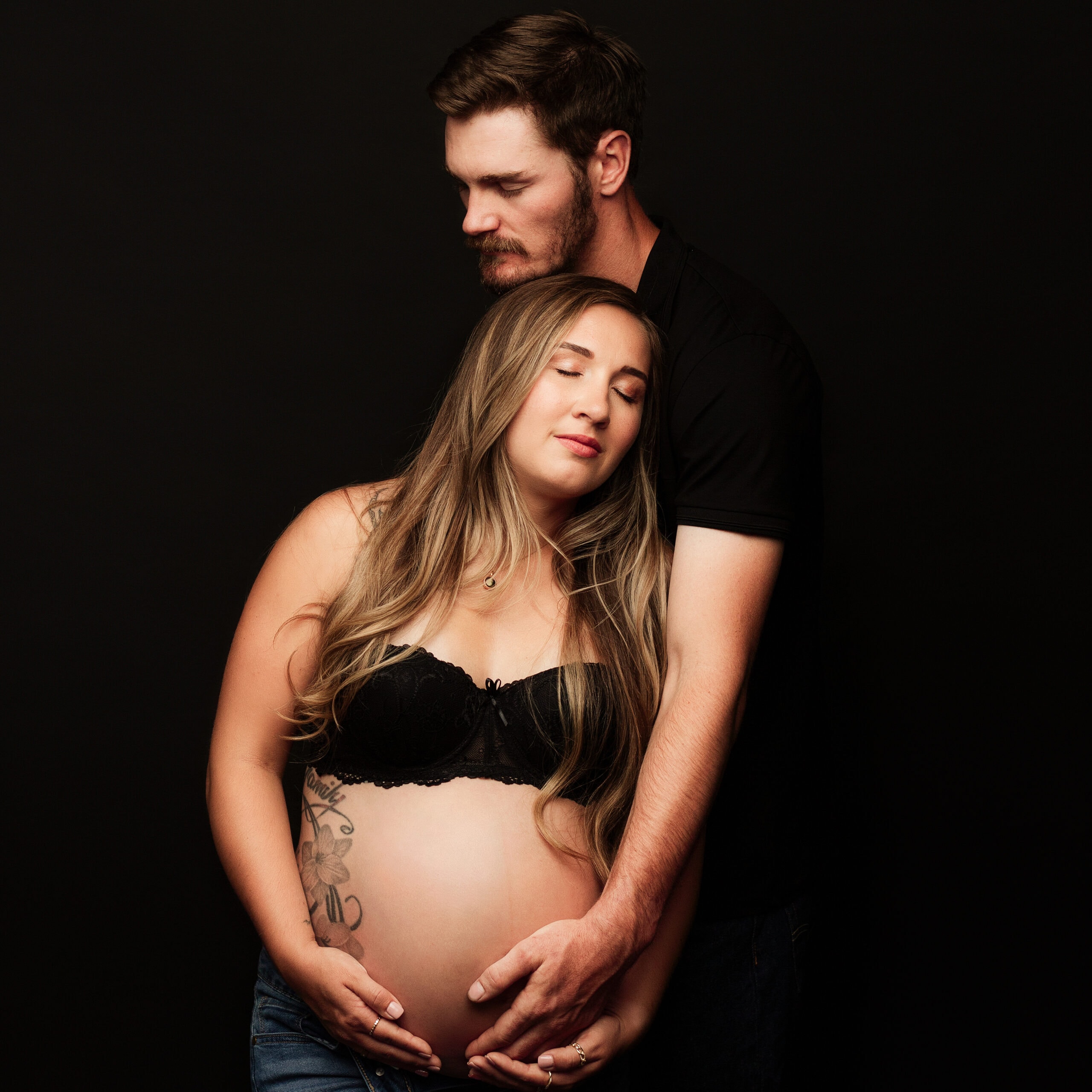 Maternity photograph with spouse in Southern Oregon photography studio.