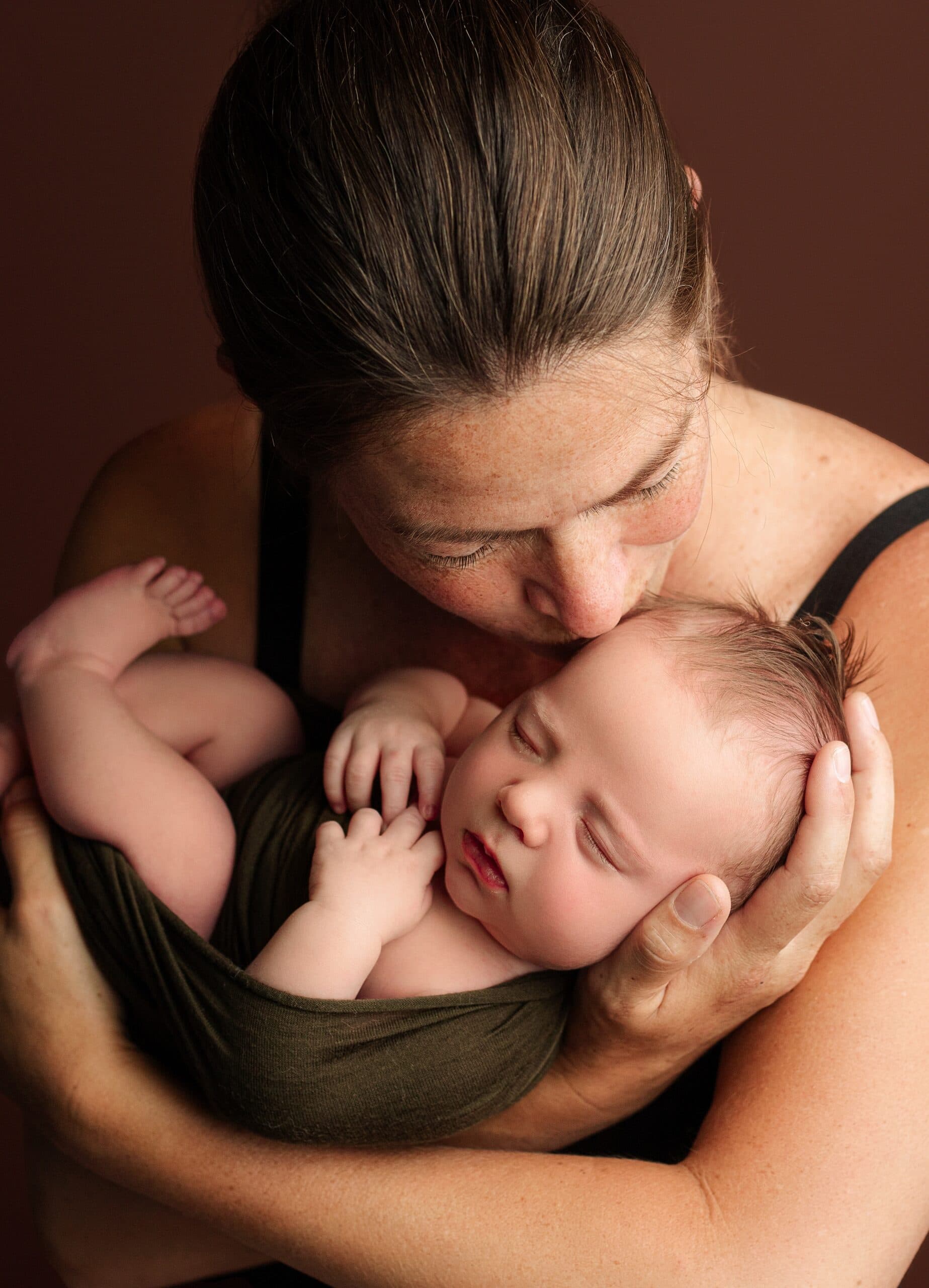 Mom holding her newborn baby boy in Grants Pass, Oregon studio.