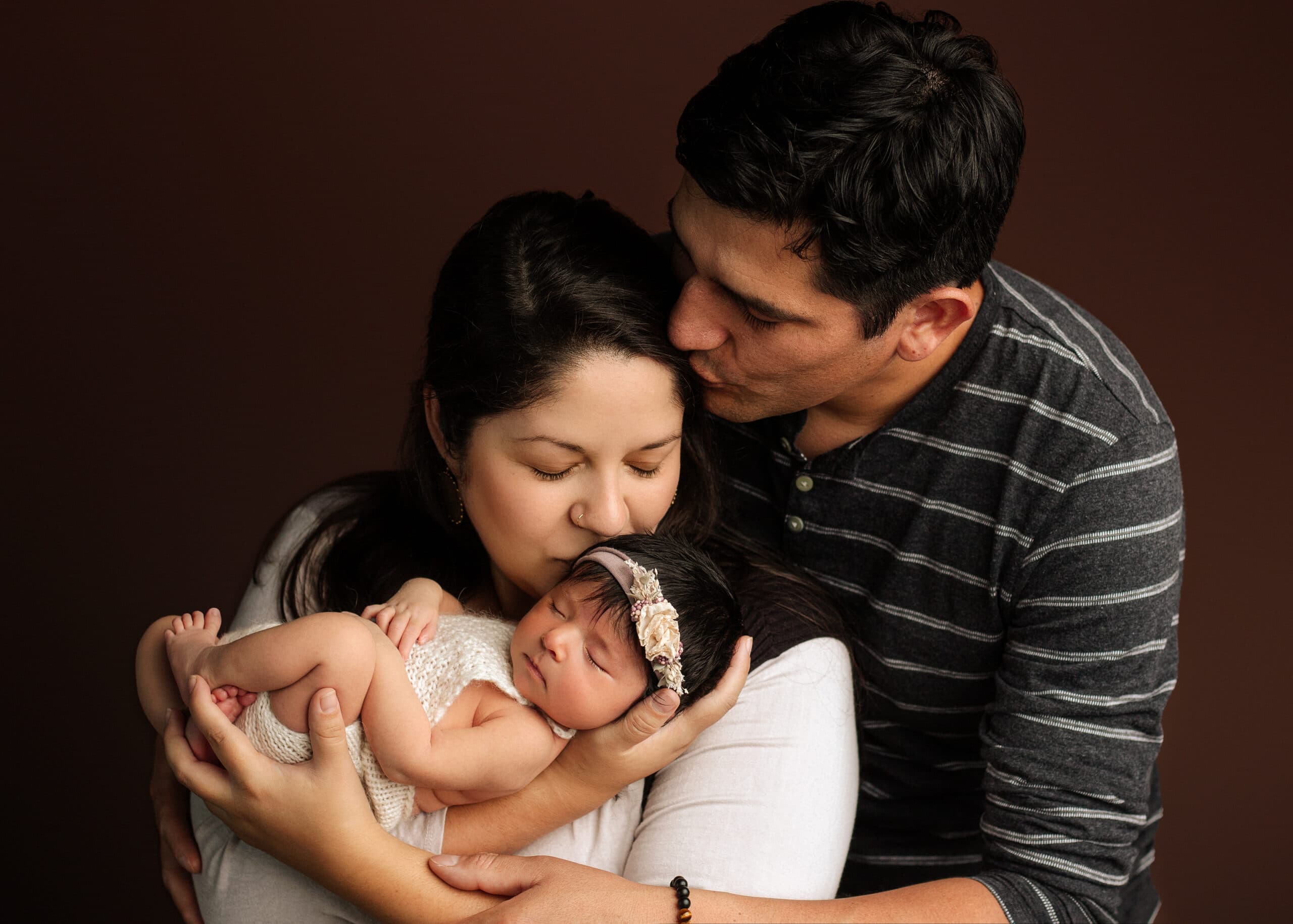 Mother and father holding newborn baby girl in Grants Pass Oregon.