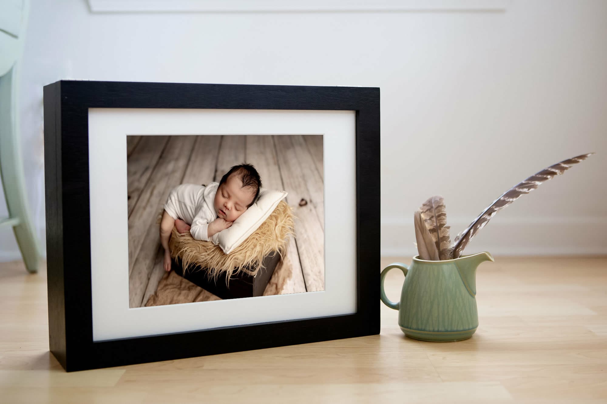 Framed photo of newborn baby in basket. Printed in Southern Oregon. 