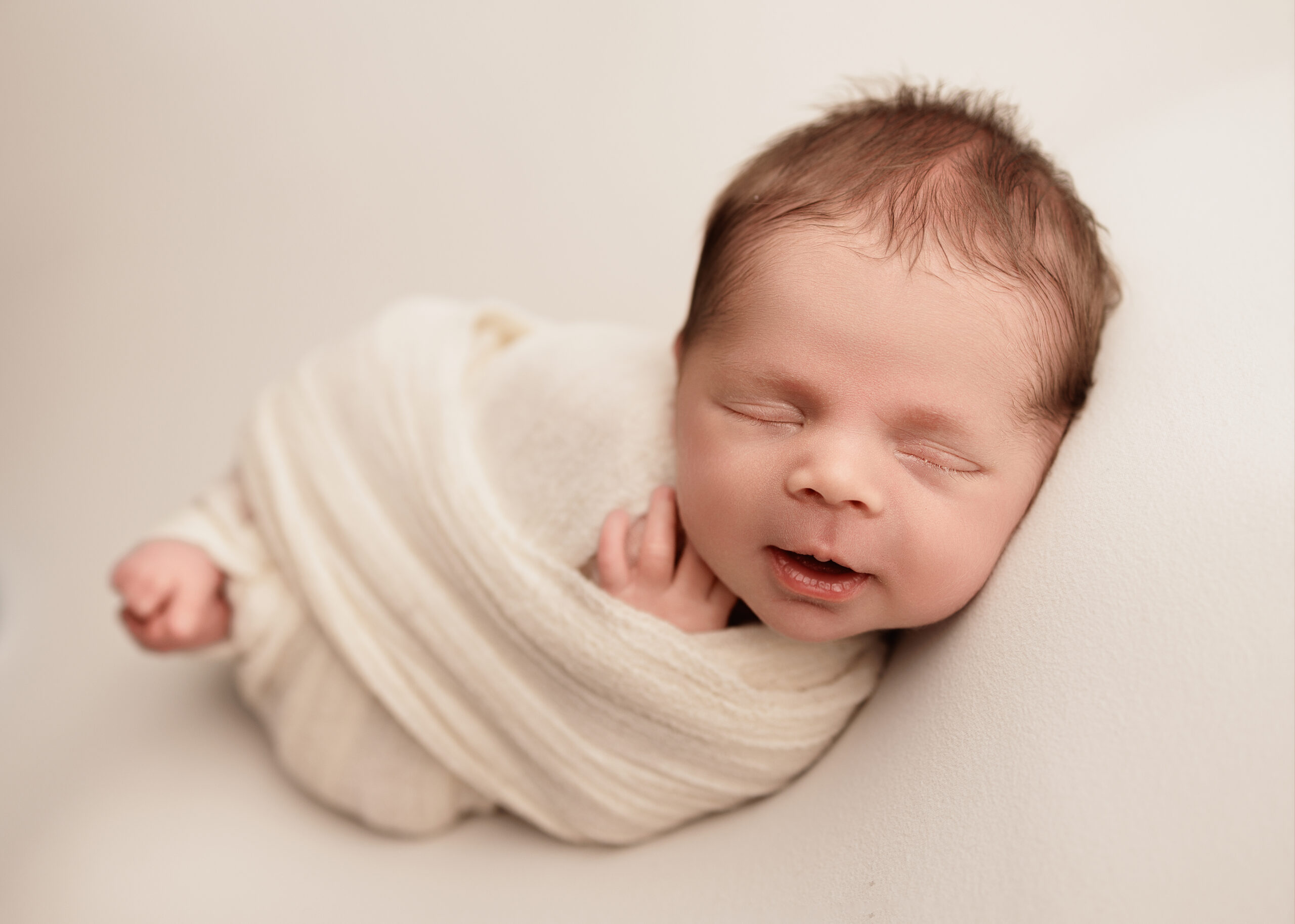 Smiling newborn posed for a baby photographer for first time parents Grants Pass