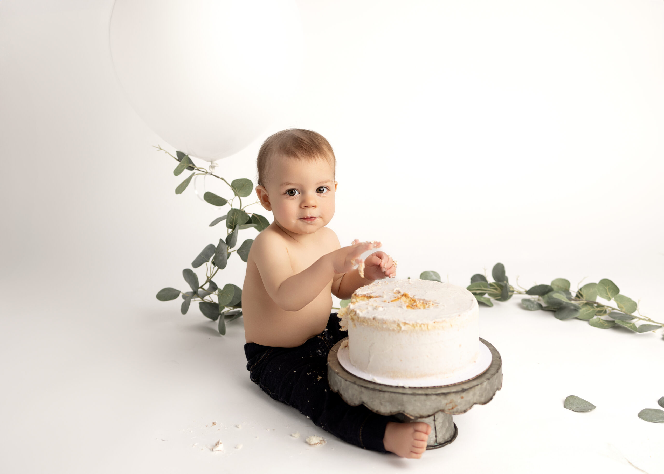 Little boy sitting in front of a cake for a cake smash photoshoot in Grants Pass
