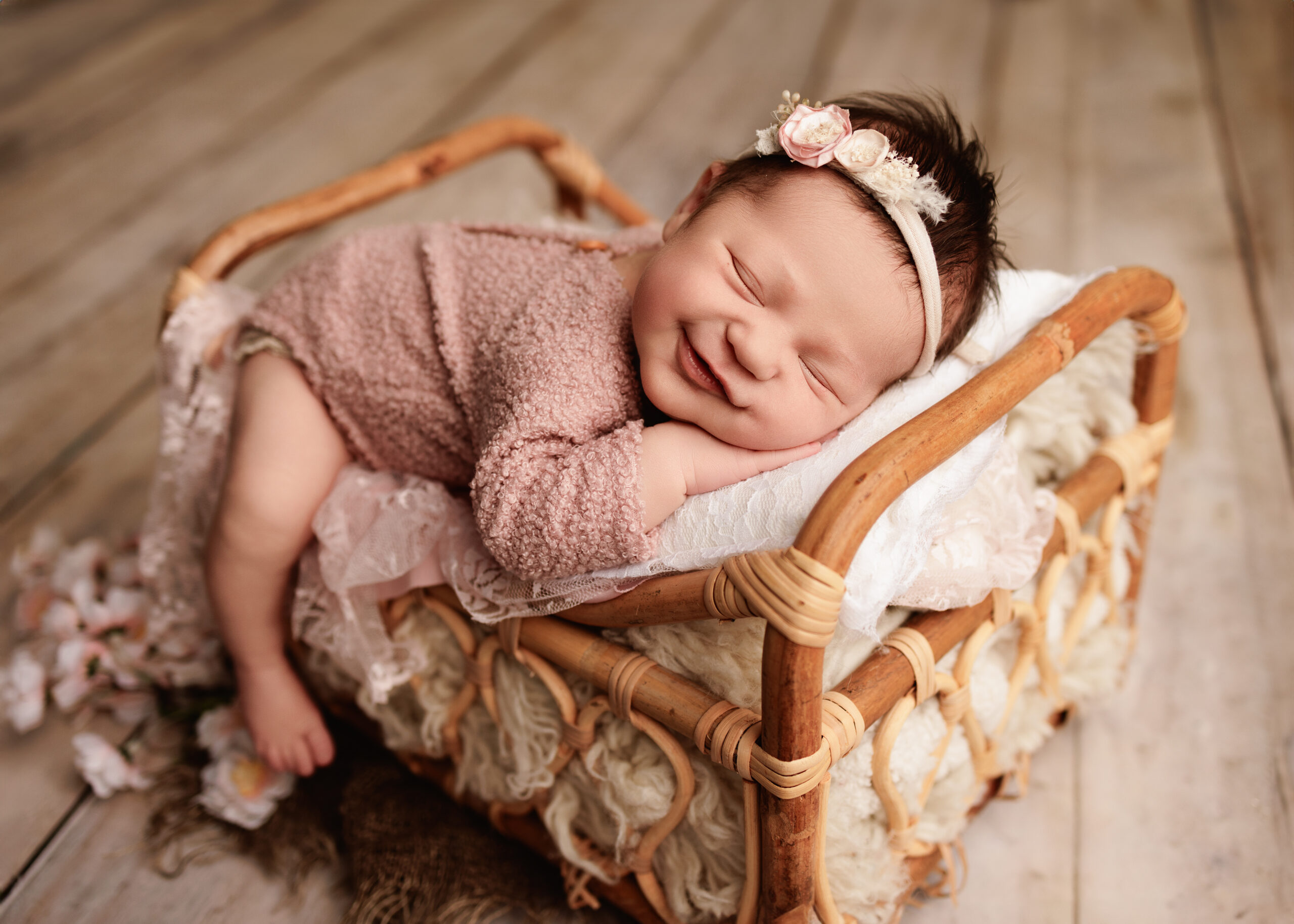 Newborn baby laying on a bed prop taken by a posed newborn photographer Grants Pass