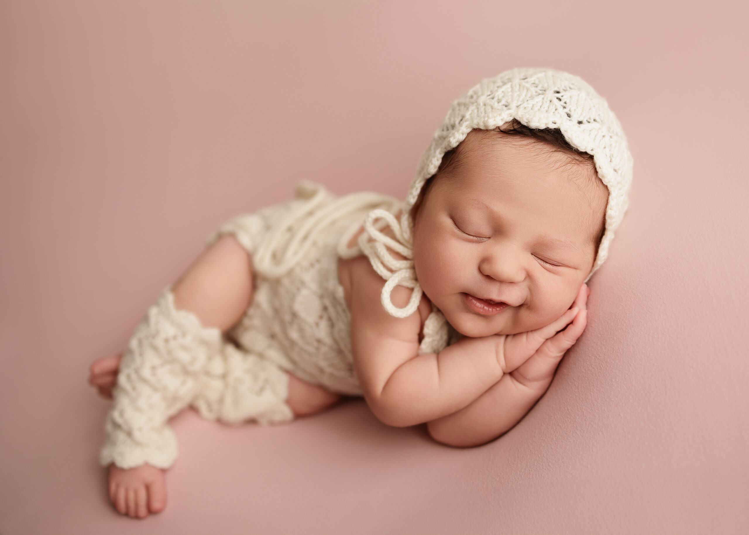 Newborn girl laying on her side at an infant photo session Grants Pass
